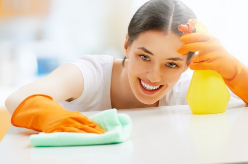 Deep cleaning team working in a Surrey property kitchen and living area