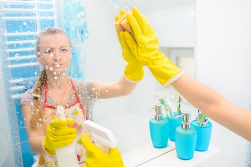 Cleaner working in a Surrey kitchen with careful attention to surfaces