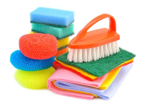 Cleaner maintaining desks and shared surfaces in a Surrey office